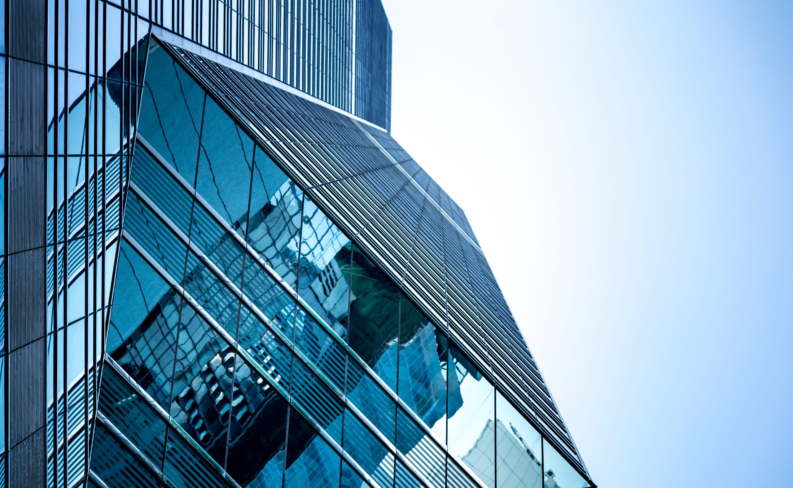 Low angle view of windows of a glass commercial building