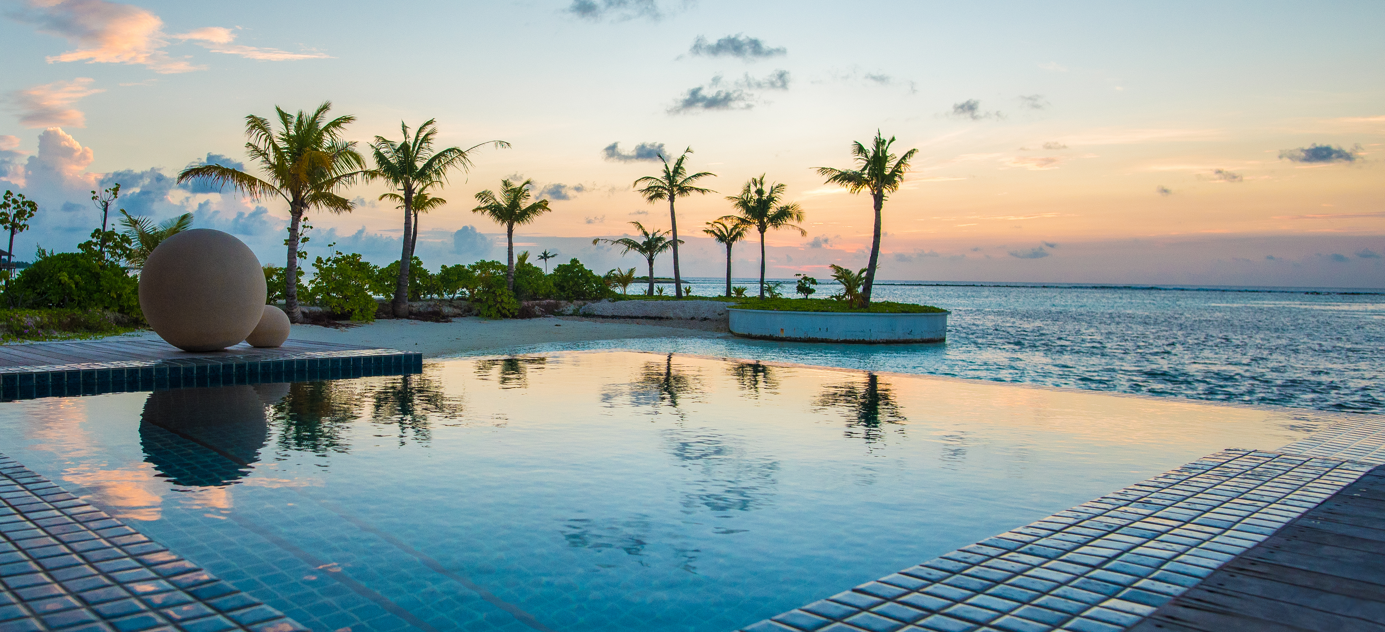 Swimming pool with a sunset