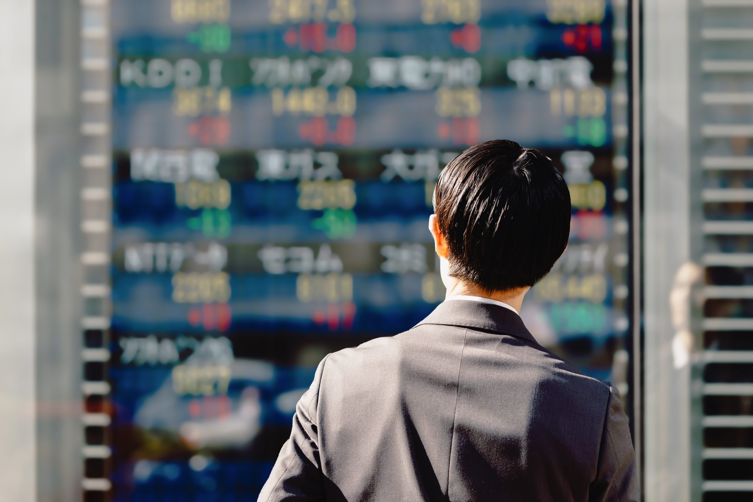 Passerby reads stock board in the street