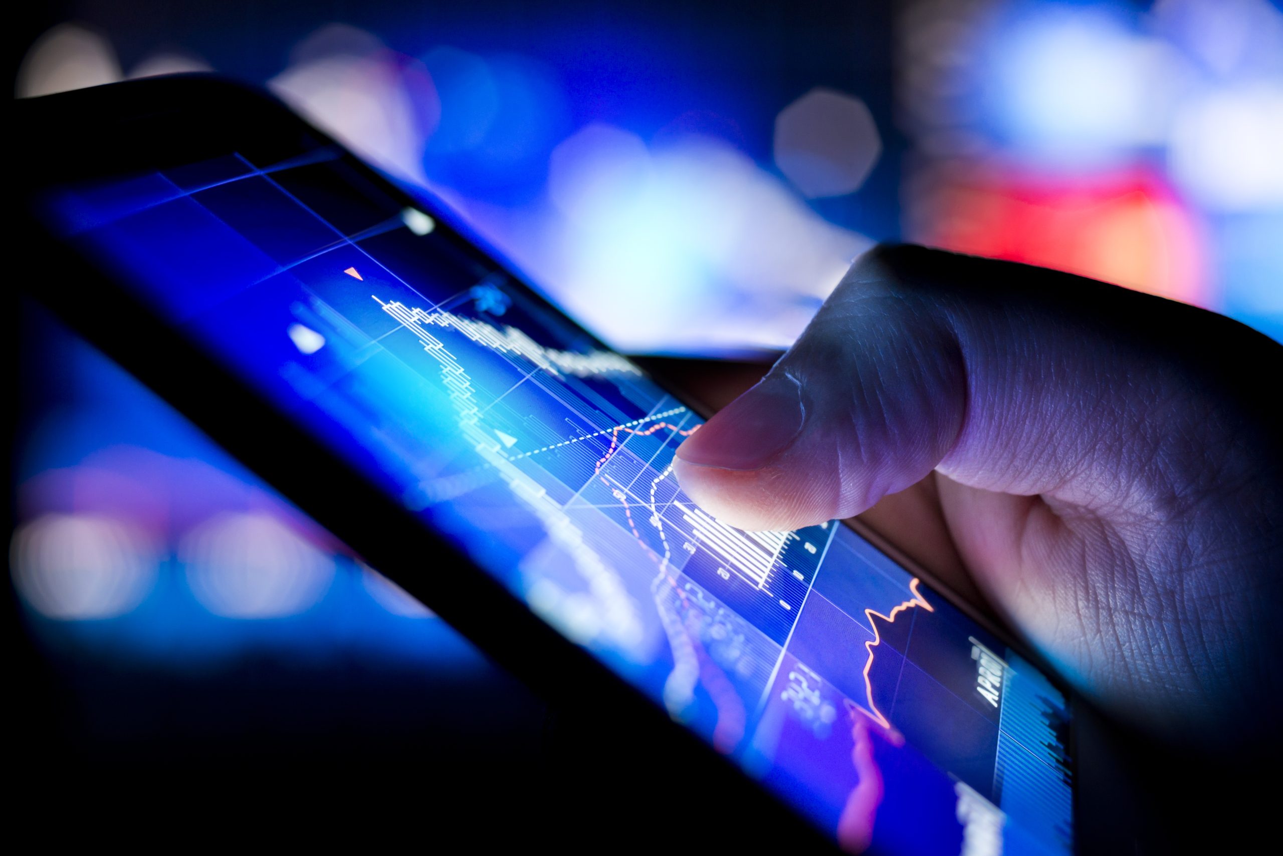 Investment analyst scrolling through data on a touchscreen display