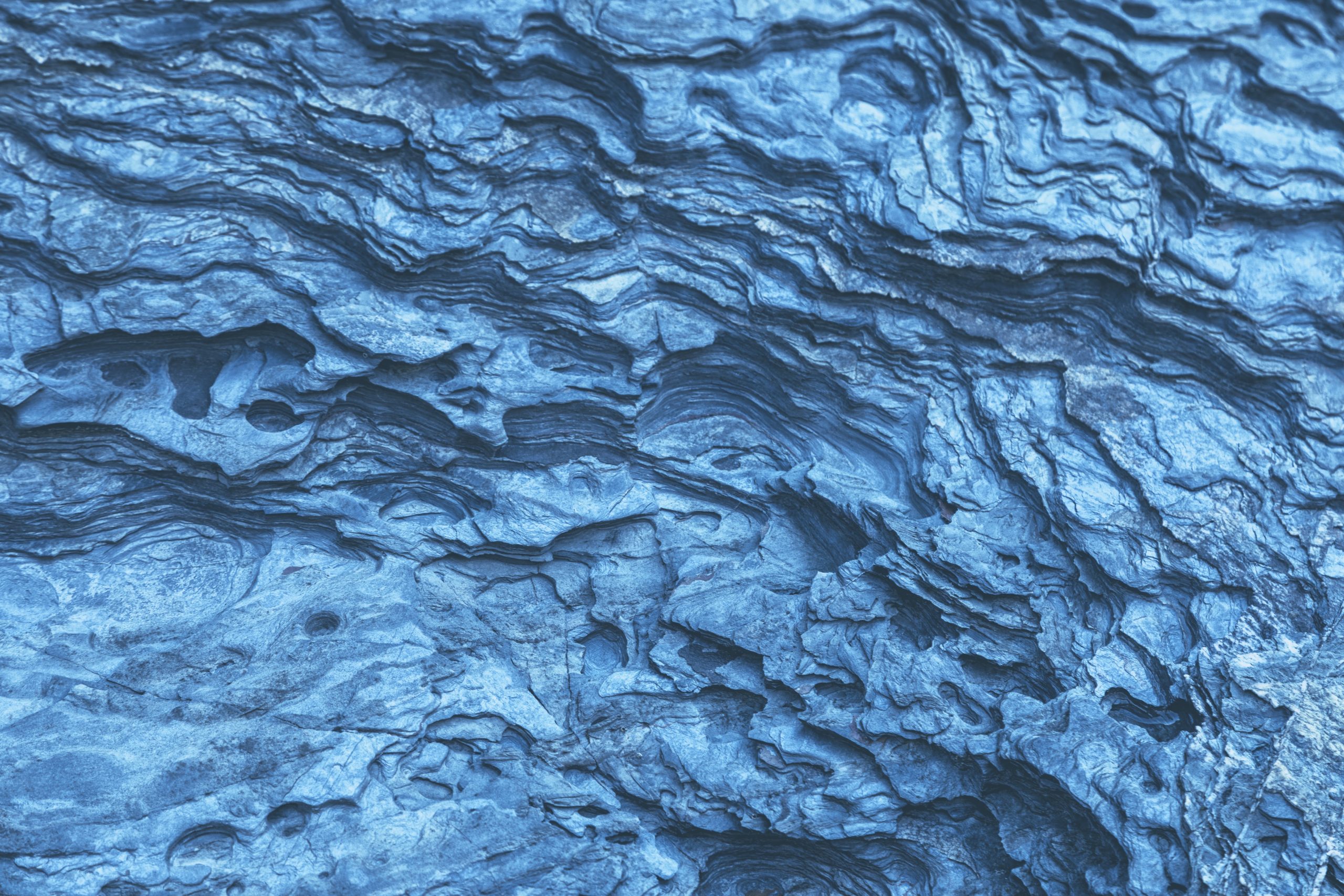 Radiant blue mineral deposits in a rock wall