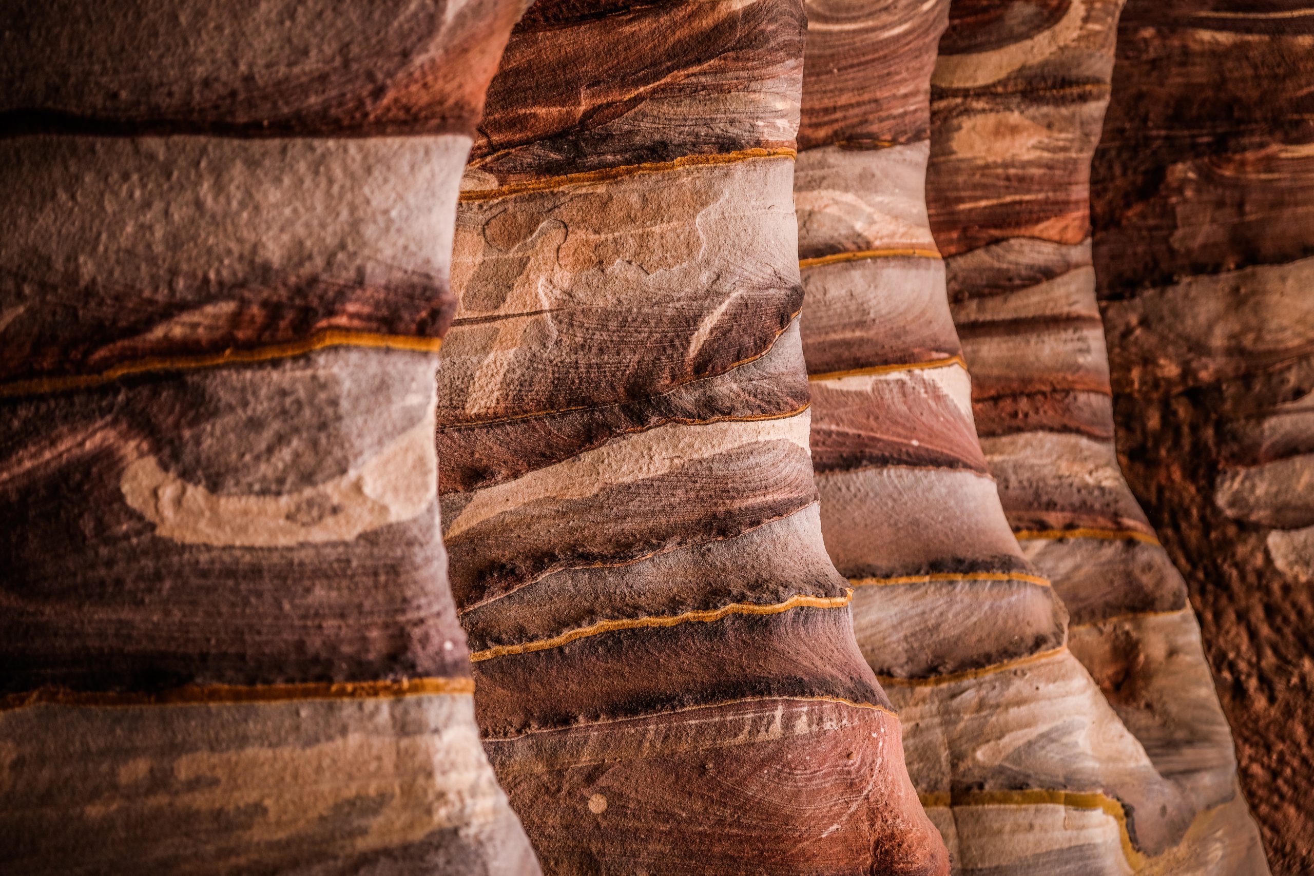 Exposed sandstone wall with layers of mineral deposits