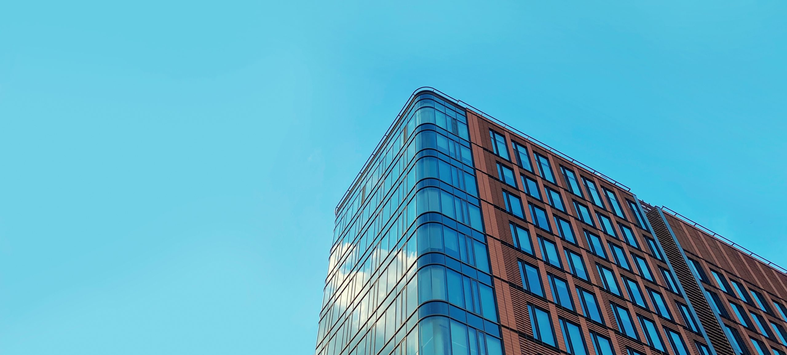 Glass fronted office building under a sunny sky